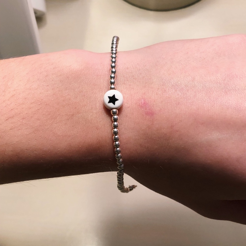 silver beaded bracelet with black and white star